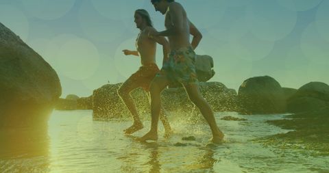 Two Male Friends Running Toward Ocean at Sunset - Download Free Stock Images Pikwizard.com