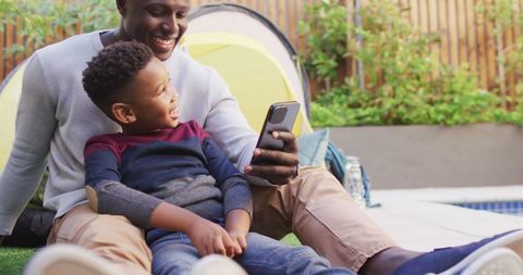 Father and Son Bonding, Enjoying Smartphone Outdoors - Download Free Stock Images Pikwizard.com