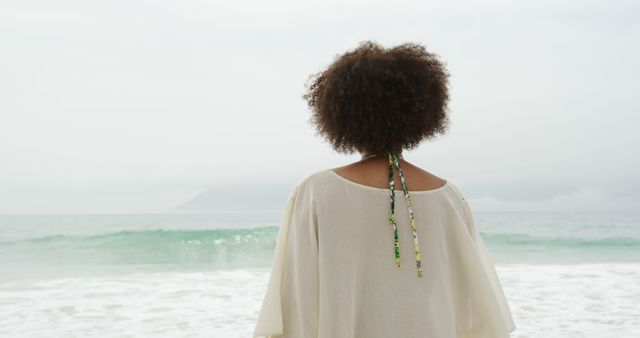 Woman Watching Ocean Waves on Overcast Day - Download Free Stock Images Pikwizard.com