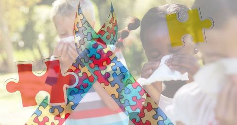 Colorful Puzzle Ribbon Overlay on Sneezing Children Representing Autism Awareness - Download Free Stock Images Pikwizard.com