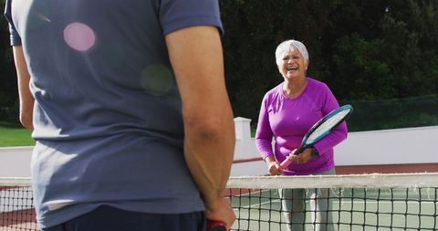 Senior Couple Enjoying Friendly Tennis Match
