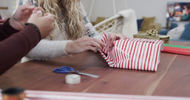 Couple Wrapping Gifts with Red and White Striped Paper - Download Free Stock Images Pikwizard.com