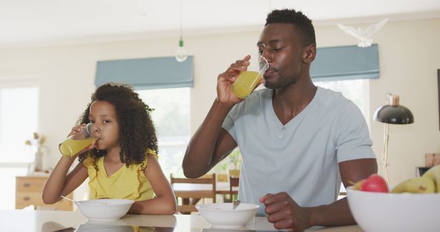 Father and Daughter Drinking Juice at Breakfast - Download Free Stock Images Pikwizard.com