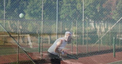 Female tennis player ready to hit ball on clay court