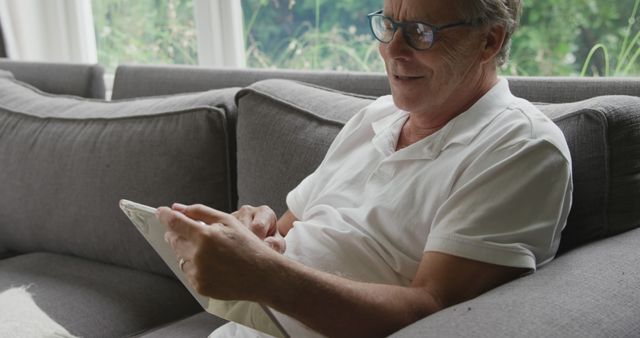 Senior Man Relaxing on Couch Using Tablet at Home - Download Free Stock Images Pikwizard.com