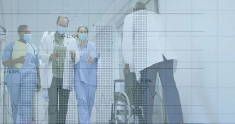 Medical Team Collaborating in Hospital Hallway With Wheelchair