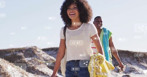 Joyful Couple Walking Through Dunes with Social Network Icons Overlay