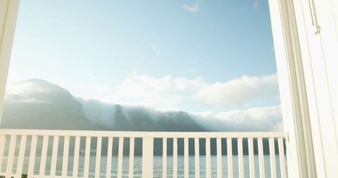 Tranquil Balcony View of Misty Mountains and Lake