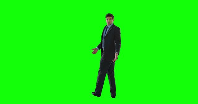 Businessman in formal suit walking on green screen background. Useful for business presentations, corporate videos, marketing materials, or any media needing isolated figure for compositing tasks.