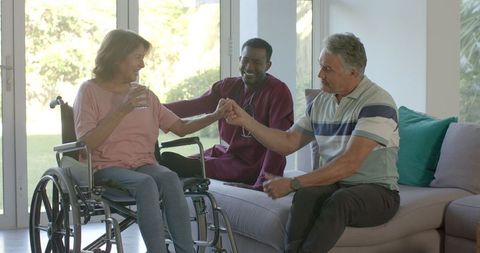 Senior Couple Interacting Joyfully with Caregiver in Home Setting