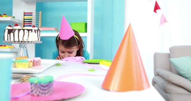 Caucasian Preschool Girl in Birthday Hat Sitting by Table - Download Free Stock Images Pikwizard.com