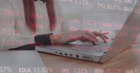 Professional Analyzing Data on Laptop with Digital Interface Overlay