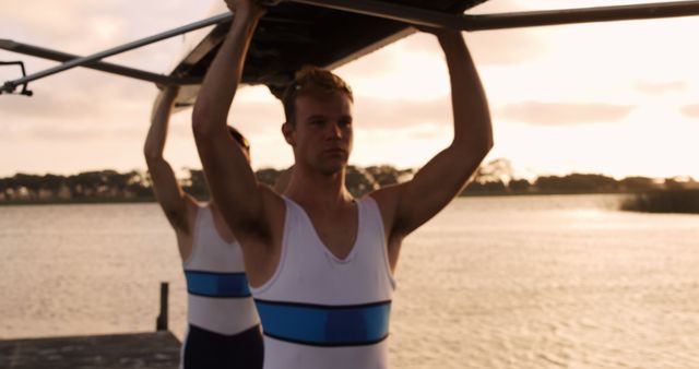 Young Rowers Carrying Boat on Calm Lake at Sunset - Download Free Stock Images Pikwizard.com