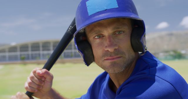 Baseball Player Wearing Helmet Holding Bat on Sunny Day - Download Free Stock Images Pikwizard.com