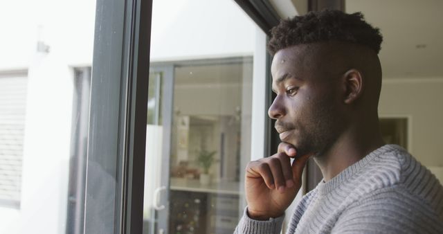 Image of thoughtful african american man looking outside window - Download Free Stock Photos Pikwizard.com