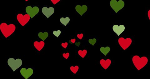 Pattern of red and green hearts on black background