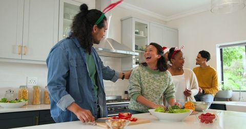 Diverse Friends Enjoying Culinary Fun in Modern Kitchen
