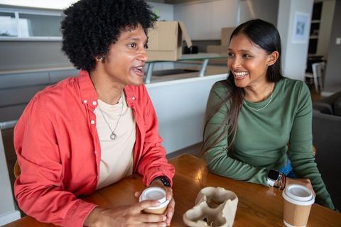 Diverse friends sharing coffee in modern home interior