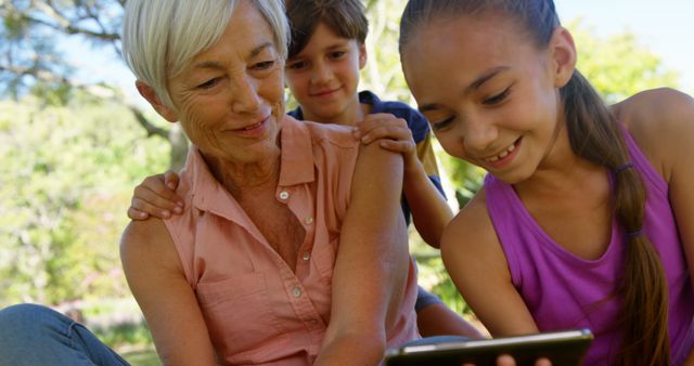 Smiling Grandmother Spending Quality Time with Grandchildren Outdoors - Download Free Stock Images Pikwizard.com