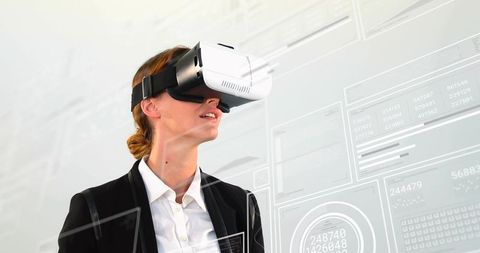 Businesswoman Interacting with Futuristic Virtual Data Interfaces