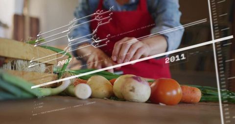 Chef Preparing Fresh Vegetables on Wooden Counter with Data Overlay Showing Produce Trends
