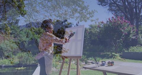 African American Woman Painting on Garden Easel Outside