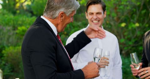 Joyful Outdoor Celebration with Laughing Guests - Download Free Stock Images Pikwizard.com