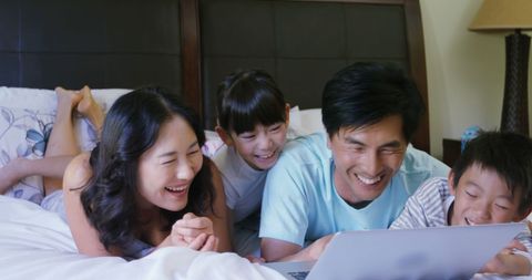 Happy Asian Family Laughing Together While Using Laptop - Download Free Stock Images Pikwizard.com
