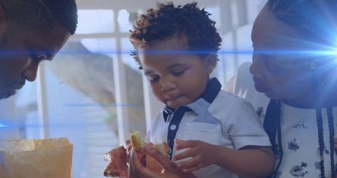 Family Breakfast: Curious Toddler and Caring Parents in Sunlit Kitchen