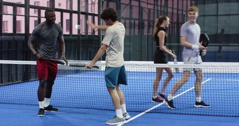 Diverse Group on Padel Court Celebrating Victory