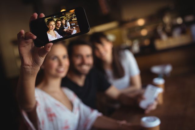 Friends taking a selfie on mobile phone - Download Free Stock Photos Pikwizard.com