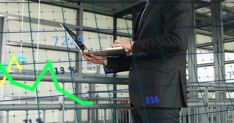 Businessman analyzing financial data on laptop with green performance chart overlay
