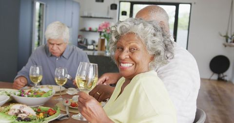 Senior Friends Enjoying Dinner Gathering with Wine