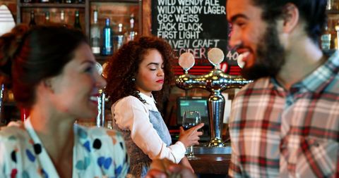 Jealous Woman Observing Couple Flirting in Pub Atmosphere - Download Free Stock Images Pikwizard.com