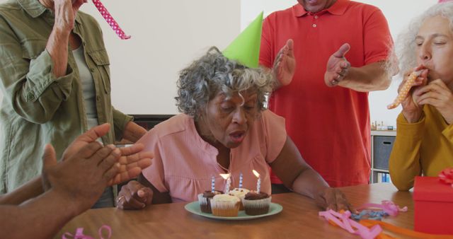 Happy senior diverse people at birthday party with cake at retirement home - Download Free Stock Photos Pikwizard.com