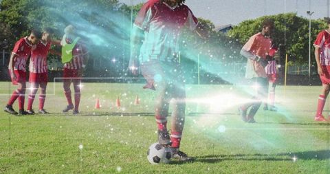 Male Soccer Player Dribbling Ball During Outdoor Training