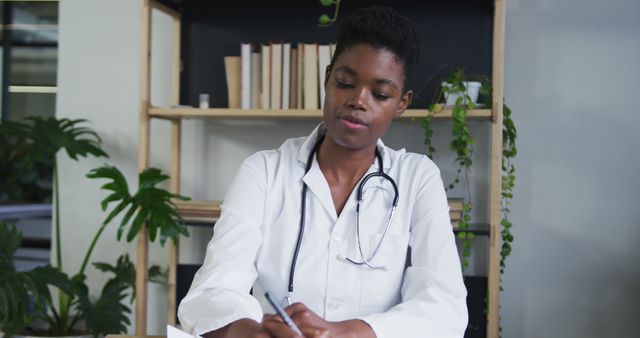 Focused Female Doctor Writing Notes in Modern Office - Download Free Stock Images Pikwizard.com