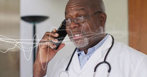 Doctor talking on smartphone with stethoscope and digital waveform for telemedicine