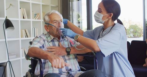 Healthcare Professional Assisting Elderly Man with Oxygen Therapy