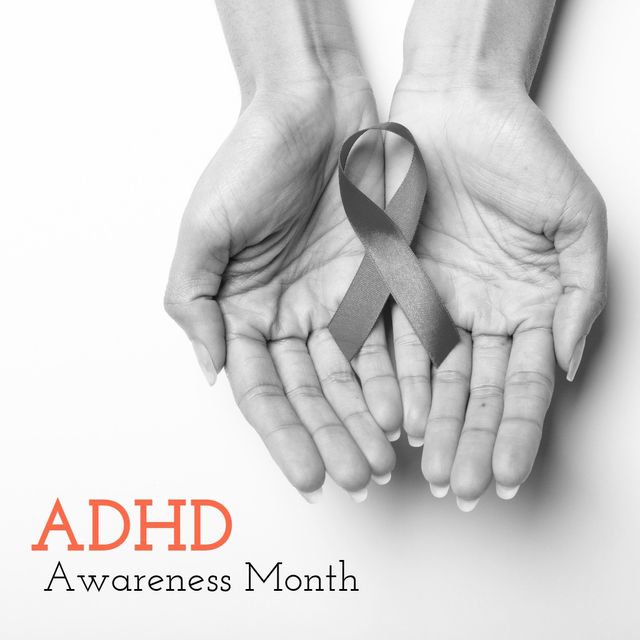 Image in black and white of hands of caucasian woman holding ribbon and adhd awareness month. Health, support and adhad awareness concept.