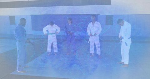 Martial arts students tying belts and preparing for jiu-jitsu training in modern dojo