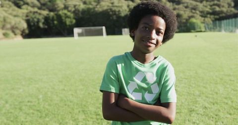 Boy Promoting Environment Awareness with Recycling Shirt on Soccer Field