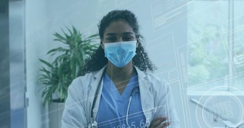 Confident doctor wearing mask in modern clinic environment