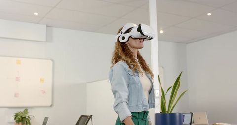 Professional Woman Engaging with Virtual Reality in Modern Office