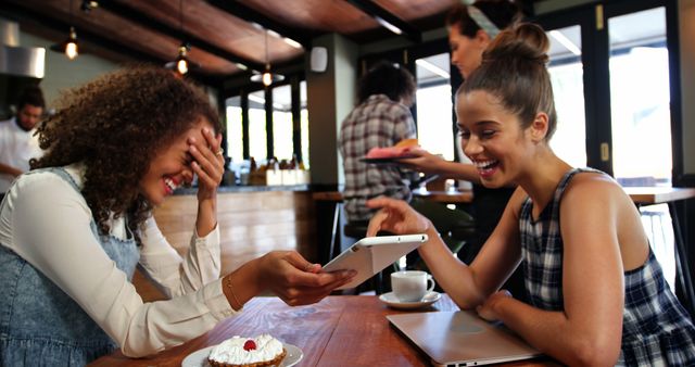 Laughing Friends Browsing Tablet Together in Coffee Shop - Download Free Stock Images Pikwizard.com