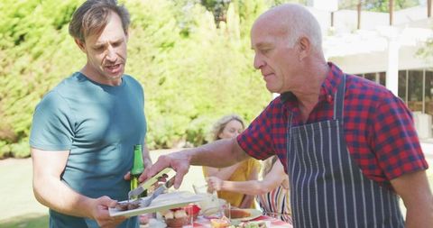 Family Barbecue in Garden Enjoying a Sunny Day Together