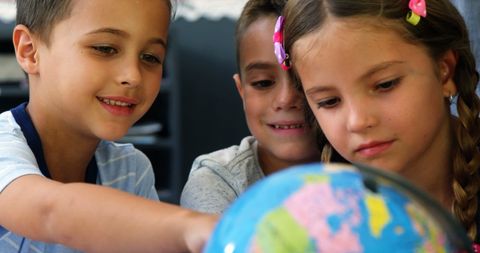 Curious School Kids Exploring World Globe Together