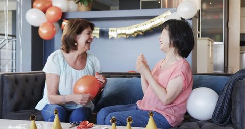 Smiling senior women preparing birthday celebration at home
