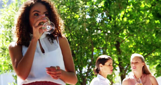 Women Socializing Outdoors, Enjoying Wine in Garden - Download Free Stock Images Pikwizard.com