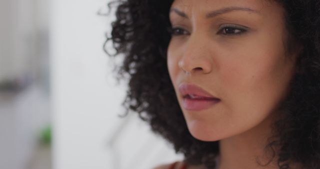 Curly Haired Woman Contemplating Thoughtfully Indoors - Download Free Stock Images Pikwizard.com